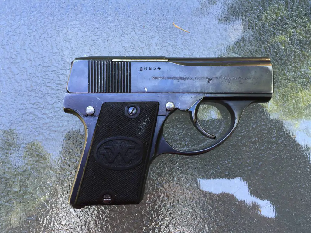 This example was made in Vienna and proofed there in 1922. Note the safety (up is safe, down - here - is fire). No sights; brass mag loads through the top!