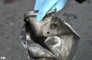 A shattered lid from a 6 liter pressure cooker. Part of one of the Marathon bombs. Image: FBI