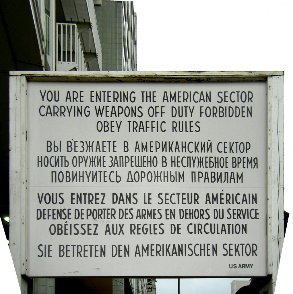 This sign once greeted refugees crossing from tyranny to (relative) freedom. Second line's ironic, eh?