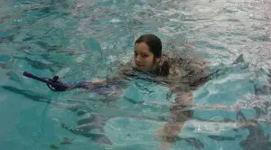 This young soldier is a ROTC Candidate at Maryland, but she's showing the combat water survival swim in ACUs with rifle. 