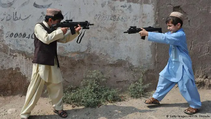 Afghan boys with toy guns