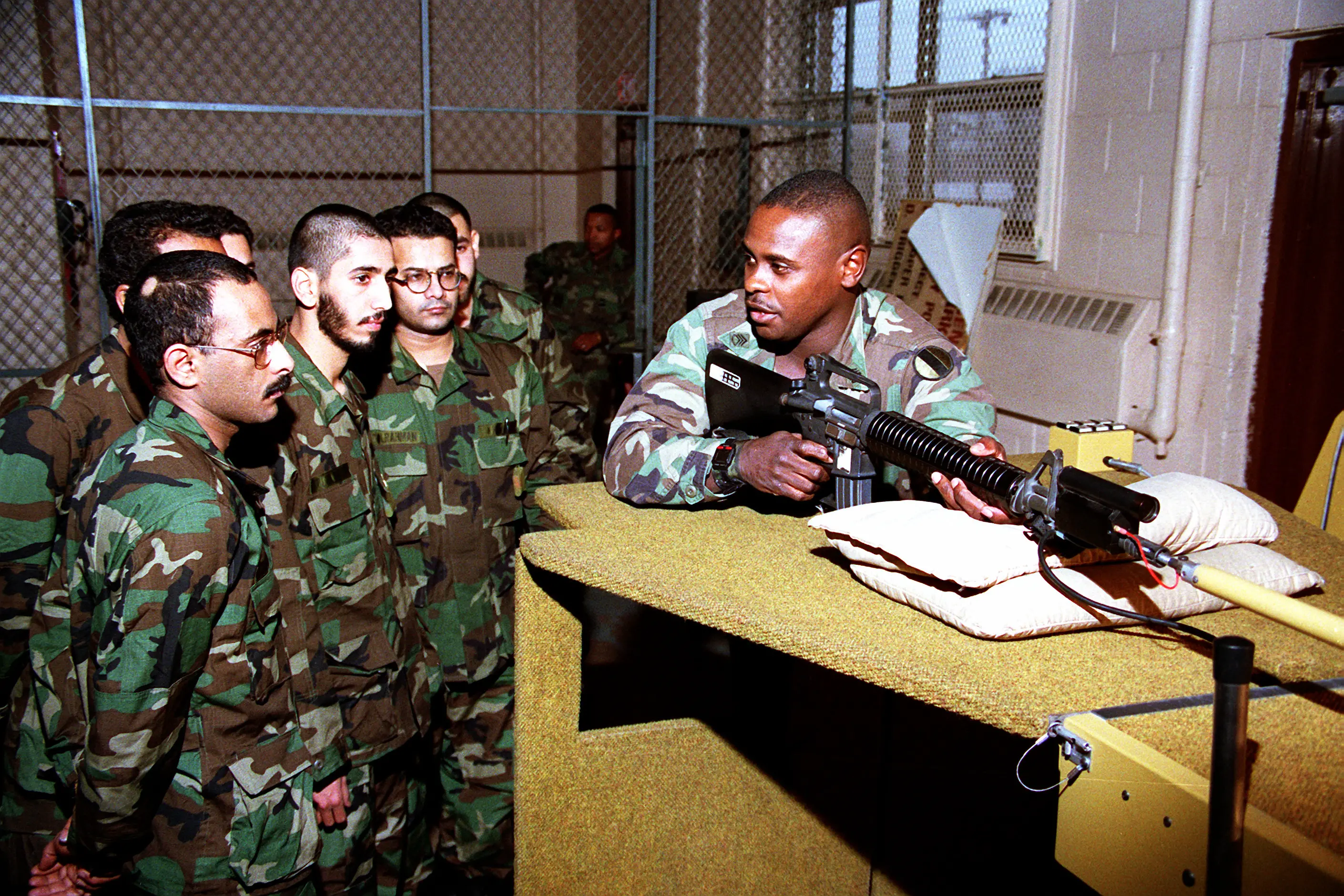 An instructor explains the weaponeer marksmanship training system to Kuwaiti soldiers during a marksmanship course. The soldiers are being trained in combat techniques in preparation for conflict with Iraqi forces presently occupying Kuwait. Fort Dix 8 Jan 91