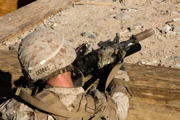 A Marine from B/1/2 Marines fires an M4 with a Knight's Armament Company suppressor attached.