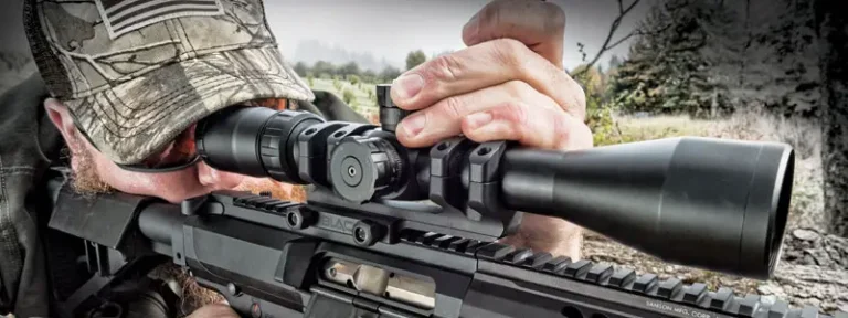 Man shooting a rifle with a scope on it