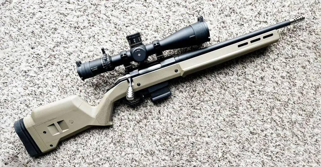 Tan Ruger American Ranch 223 Rifle on carpet with scope